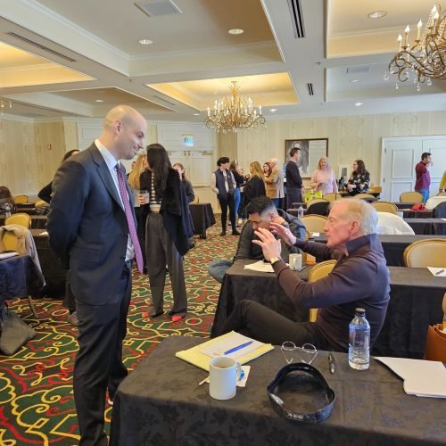 Bill speaks with firm partner Noah Peters at the 2023 firm retreat at The Broadmoor.