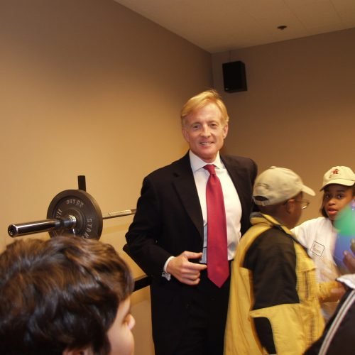 Bill showing FLP students the firm's in-office gym in 2002.