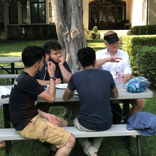Bill speaks with FLP students at an FLP summer party at his home in 2018.