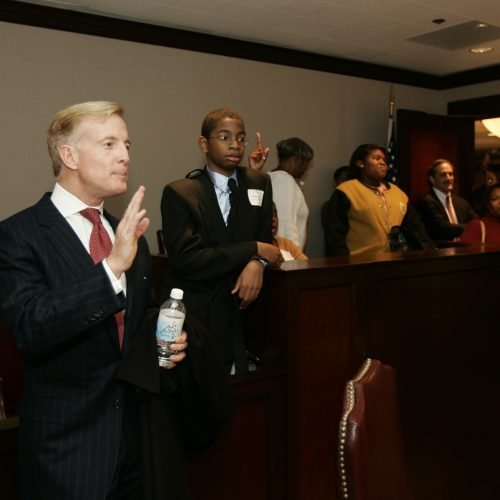Bill in the firm's mock courtroom with FLP students in 2004.